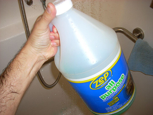 All-Purpose cleaner concentrate & degreaser held by a man for Shower Drain Unclogging