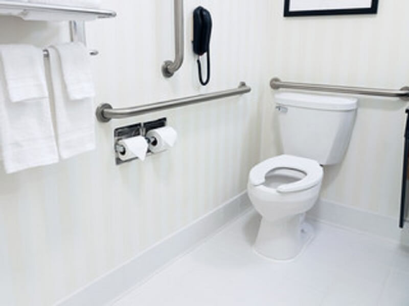 two piece toilet in a white bathroom for the comparison of one piece vs two piece toilet